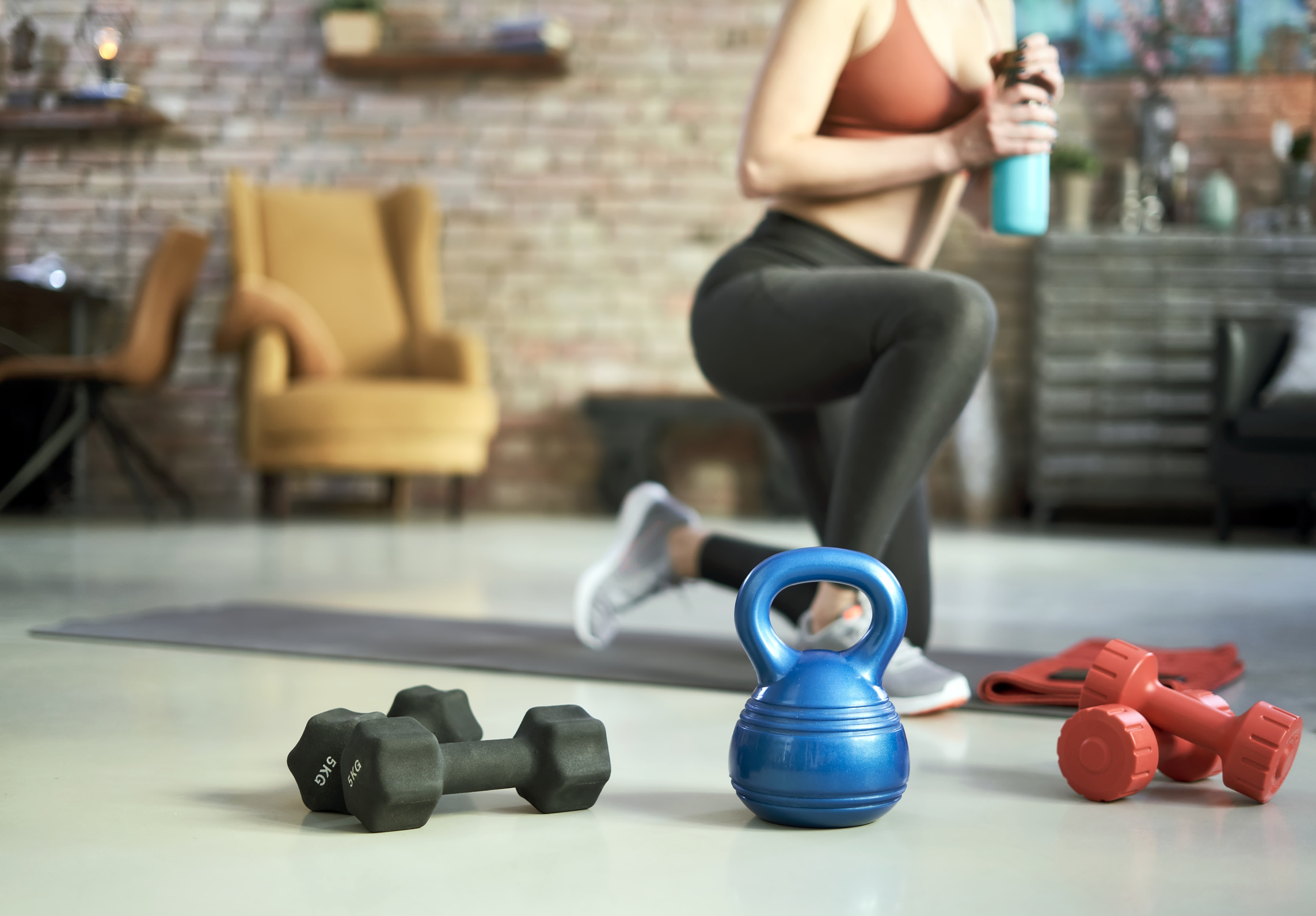 Woman Doing Home Workout with Fitness Equipment at Home